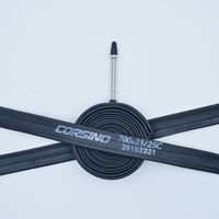 Image of a compactly rolled-up Corsino bike tube FV60mm, size 700x23/25C. The black rubber tube features a 60mm valve.