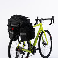 Pannier Bag 75L in black, made of water-resistant 500D PVC Twill Fabric. Top dimensions: 31x15x49cm, sides dimensions: 29.5x15x34cm, weight: 2300g. Features a multi-functional design with two shoulder bags and a backpack, all attached to a bike pannier.