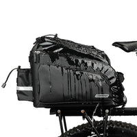 Water resistant Corsino Quest 17L bike trunk bag repelling heavy water while mounted on a rear rack, demonstrating its durable PVC construction and all-weather protection