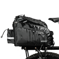 Water resistant Corsino Quest 17L bike trunk bag repelling heavy water while mounted on a rear rack, demonstrating its durable PVC construction and all-weather protection