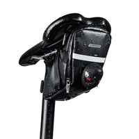 Extreme close-up demonstrating the absolute waterproof performance of the Corsino Transit saddle bag. Water instantly beads up and rolls off the rugged 600D TPU exterior, guaranteeing your sensitive electronics and steel tools stay completely bone-dry during heavy rainstorms.