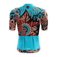 Back profile of the teal blue Tribal jersey for women, illustrating the ergonomic rear pocket system designed to carry tools and nutrition securely on every ride