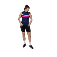 A female rider sporting the dark navy, pink, and white Corsino Elie sleeveless bike shirt. Showcasing the flawless, drag-reducing second-skin fit and advanced cooling technology engineered to actively evaporate sweat and keep endurance cyclists completely dry on grueling road climbs