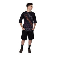 A mountain biker fully geared up in the black Corsino Lines 3/4 Sleeve MTB Jersey. The action-ready comfort fit and protective sleeve length offer the perfect balance of trail durability and cooling performance for aggressive gravity riders