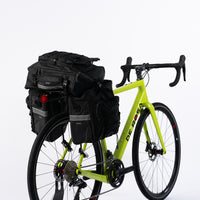 Pannier Bag 75L in black, made of water-resistant 500D PVC Twill Fabric. Top dimensions: 31x15x49cm, sides dimensions: 29.5x15x34cm, weight: 2300g. Features a multi-functional design with two shoulder bags and a backpack, all attached to a bike pannier.