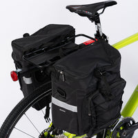 Pannier Bag 75L in black, made of water-resistant 500D PVC Twill Fabric. Top dimensions: 31x15x49cm, sides dimensions: 29.5x15x34cm, weight: 2300g. Features two shoulder bags attached to a bike pannier.