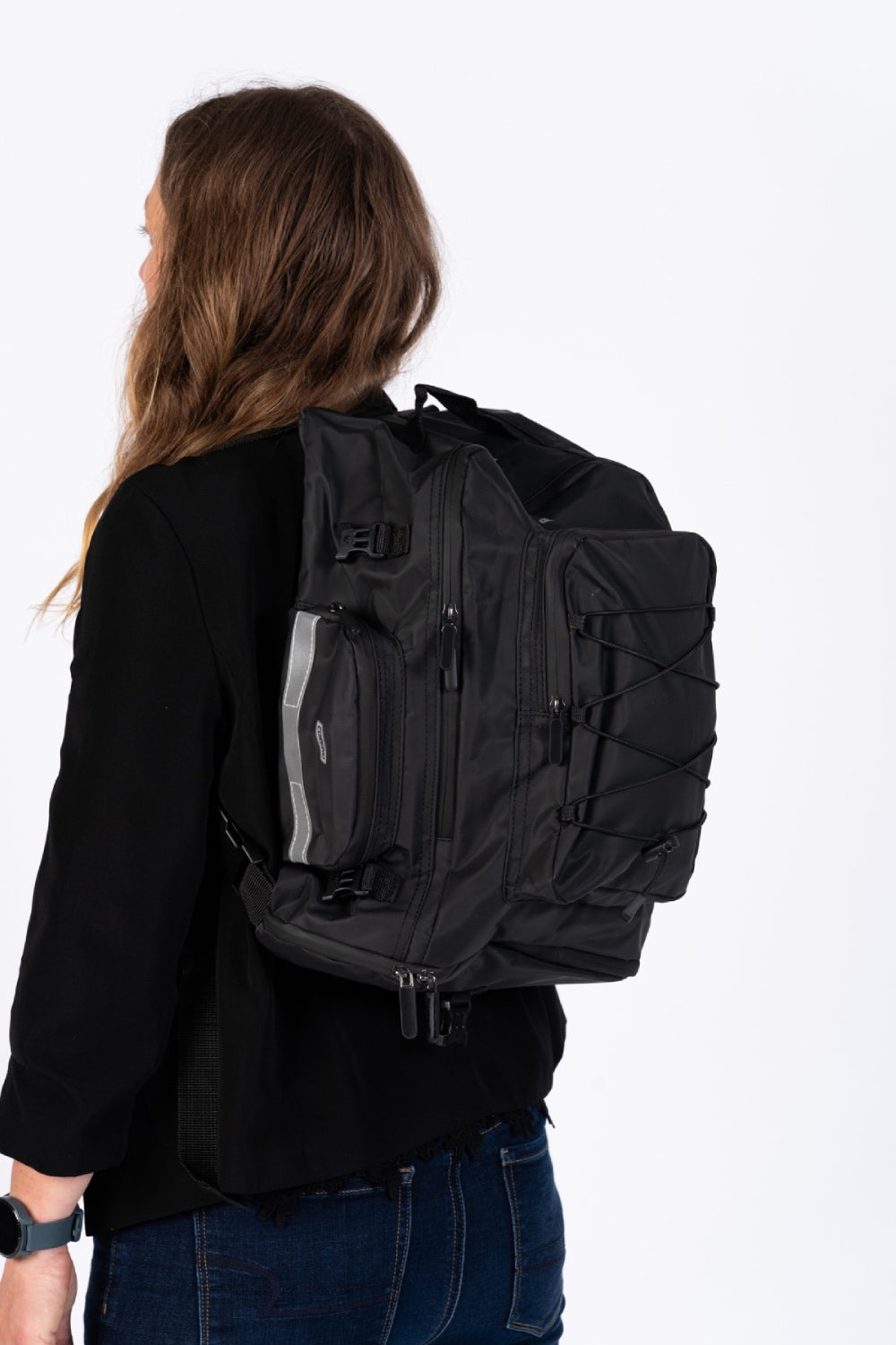 Corsino Pannier Bag 75L in black, made from water-resistant 500D PVC Twill Fabric, shown being used as a backpack with shoulder straps.
