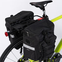 Pannier Bag 75L in black, made of water-resistant 500D PVC Twill Fabric. Top dimensions: 31x15x49cm, sides dimensions: 29.5x15x34cm, weight: 2300g. Features two shoulder bags attached to a bike pannier.