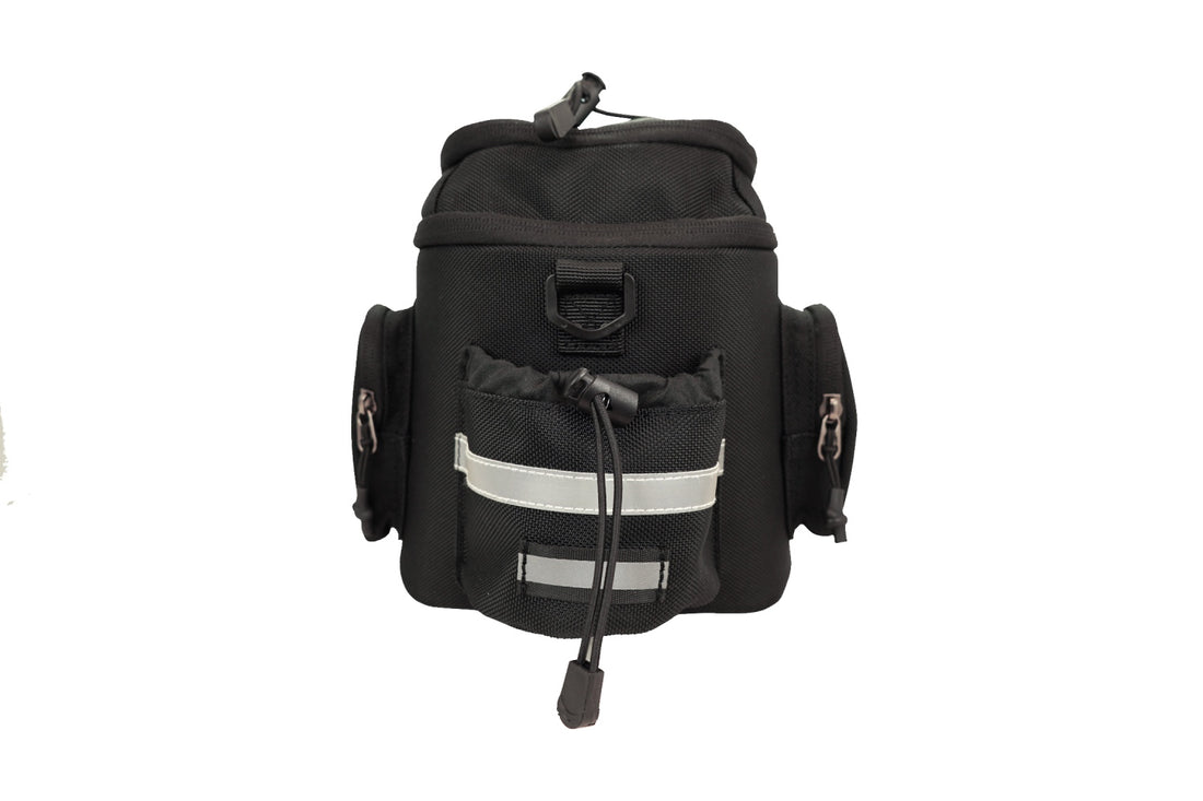 Back profile of the 800g Corsino Adventure 12L cycling day trip bag featuring a tail light hang strap, reflective logo for nighttime visibility, and a leak-proof bottle holder