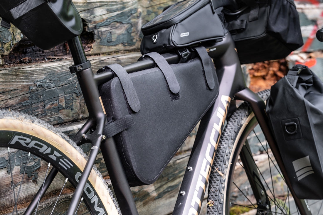 Front-angled view of the black Corsino Excursion bicycle triangle bag, showcasing the sleek, aerodynamic profile that maximizes central frame storage without ever interfering with the rider's pedal stroke.
