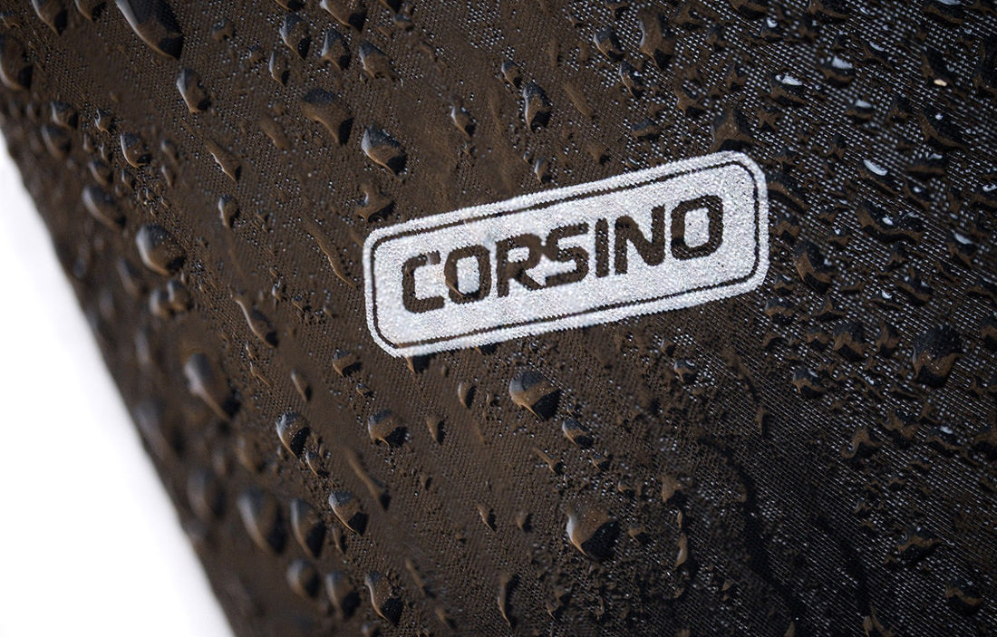 Close-up macro shot of the premium waterproof polyester fabric on the Corsino Jaunt bike bag. Engineered to actively repel road spray and sudden rain showers, keeping your delicate electronics and repair tools completely dry.