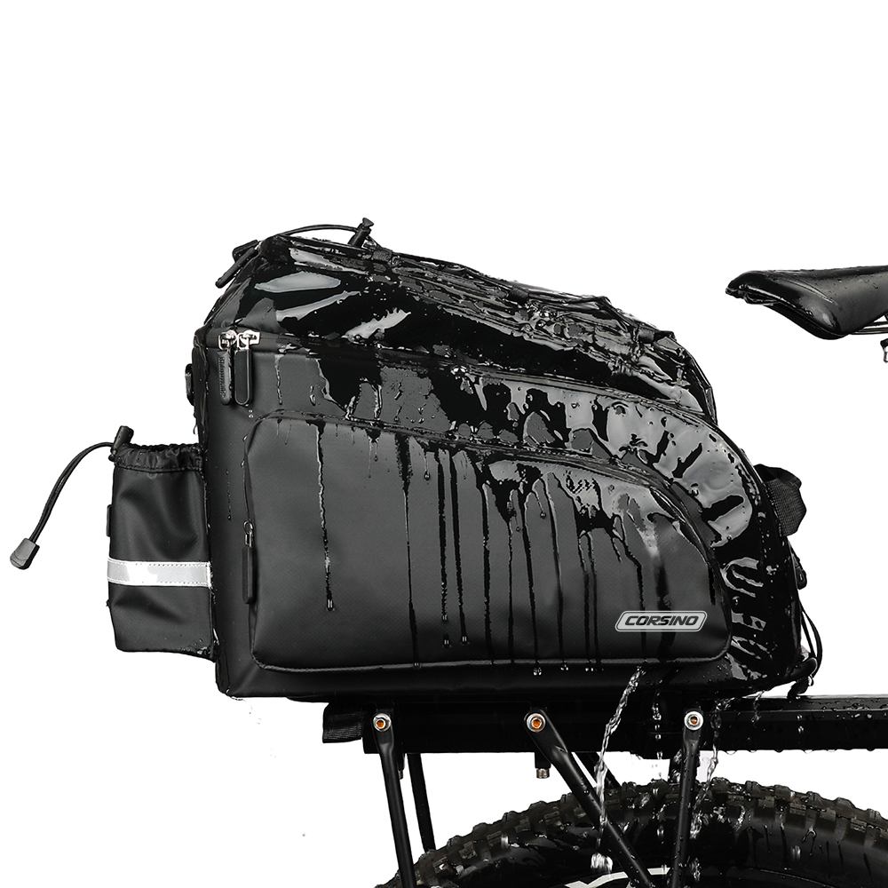 Water resistant Corsino Quest 17L bike trunk bag repelling heavy water while mounted on a rear rack, demonstrating its durable PVC construction and all-weather protection