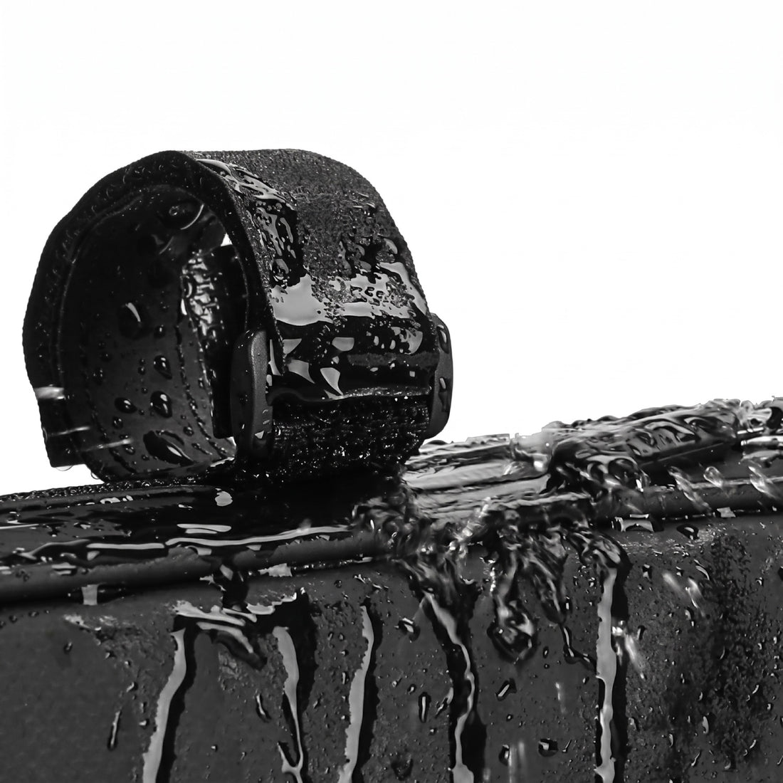 Close-up demonstrating the water-resistant premium polyester material of the Corsino Shortcut bike frame bag repelling heavy water droplets to protect your cycling gear from the elements
