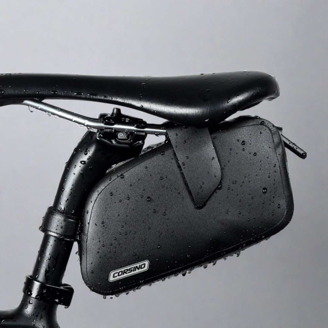 The sleek black Corsino Transit saddle bag resting perfectly against the seat post. A must-have minimalist tool pouch for serious cyclists demanding elite waterproof performance without sacrificing their bike's clean, aggressive lines.