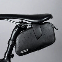 The sleek black Corsino Transit saddle bag resting perfectly against the seat post. A must-have minimalist tool pouch for serious cyclists demanding elite waterproof performance without sacrificing their bike's clean, aggressive lines.