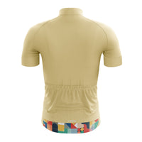 Rear view of the tan Venti Women's Jersey showing the 3 rear bag pockets, 1 zip pocket, and reflective bands designed to minimize aerodynamic resistance