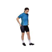 Female athlete wearing the blue Corsino Cloud short sleeve jersey from the front, demonstrating how the comfort fit and Technica Coolway fabric comfortably conform to the body