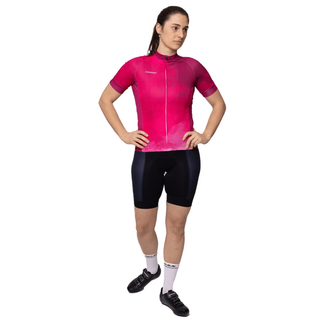Female cyclist wearing the pink Corsino Cloud short sleeve jersey from the front, highlighting the sleek full covered zipper and 4cm compression cuffs on the arms