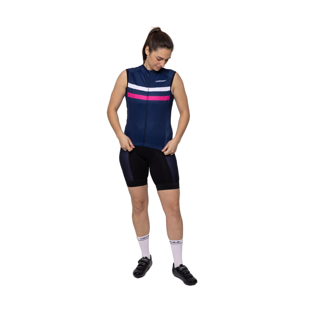 A female rider sporting the dark navy, pink, and white Corsino Elie sleeveless bike shirt. Showcasing the flawless, drag-reducing second-skin fit and advanced cooling technology engineered to actively evaporate sweat and keep endurance cyclists completely dry on grueling road climbs