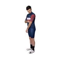 Competitive male cyclist riding aggressively in the Corsino FastNFree aero jersey. The longer pro sleeve length and flawless anatomic fit guarantee maximum aerodynamic efficiency for breaking personal records on the tarmac