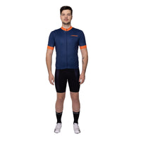 Male cyclist wearing the navy blue Corsino Tremblant short sleeve jersey from the front, demonstrating the snug compression side panels and Giro cut sleeves for an anatomic fit