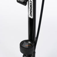 Close-up of the Corsino bike floor pump's highly versatile dual-compatible head. Engineered to seamlessly lock onto both Presta and Schrader valves, ensuring an airtight, effortless tire inflation process for any road or mountain bike setup.
